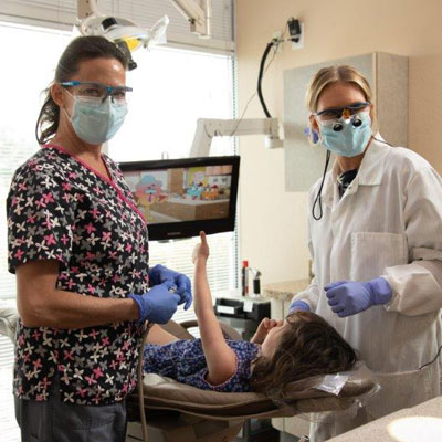 Doctor Mack with dental assistant and patient