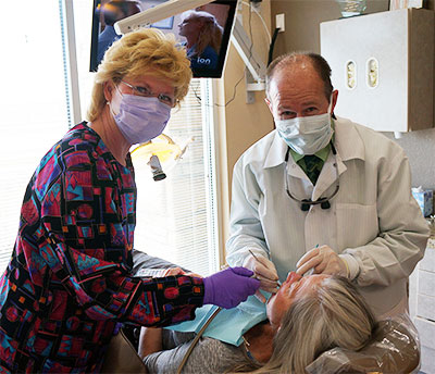 Doctor Gerry with dental assistant and patient